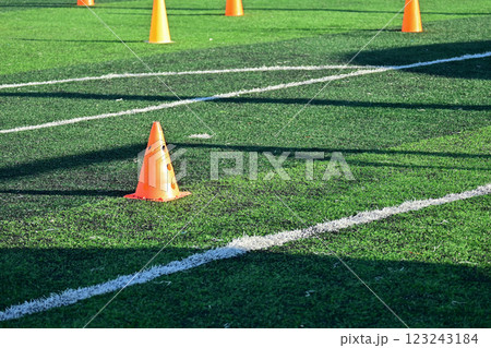 artificial green grass soccer field with orange training cones 123243184