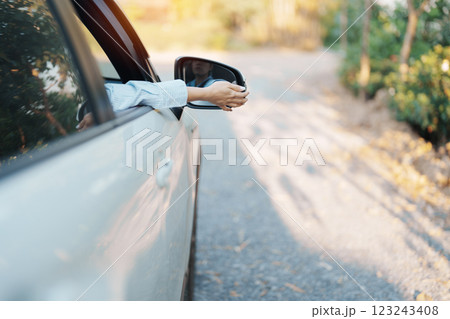 Business woman driver adjusting side view mirror a car. Journey, trip and safety Transportation concepts 123243408