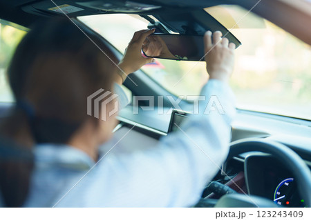 Business woman driver adjusting rear view mirror a car. Journey, trip and safety Transportation concepts 123243409
