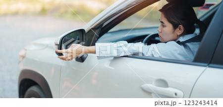 Business woman driver adjusting side view mirror a car. Journey, trip and safety Transportation concepts 123243414