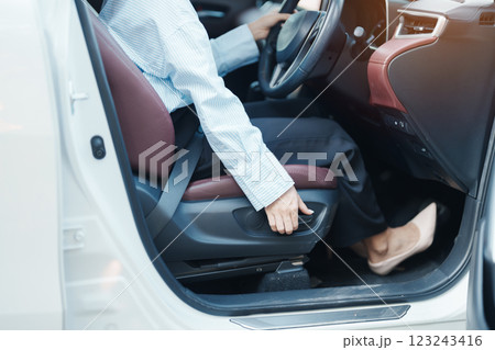 Business woman hand adjust car seat before drive on the road. Ergonomic, health care and safety transportation concept Business woman hand adjust car seat before drive on the road. Ergonomic, health care and safety transportation concept 123243416
