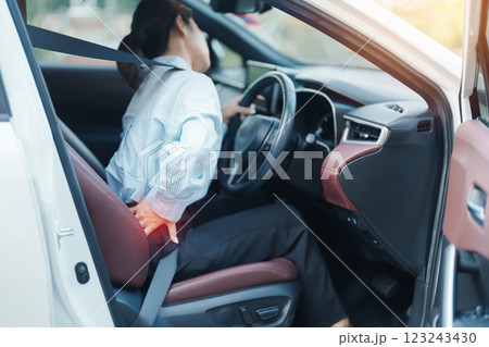 woman with her back sprain while driving car long time, back body ache due to Piriformis Syndrome, Low Back Pain and Spinal Compression. Ergonomic and medical concept 123243430