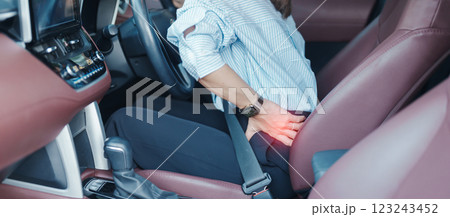 woman with her back sprain while driving car long time, back body ache due to Piriformis Syndrome, Low Back Pain and Spinal Compression. Ergonomic and medical concept woman with her back sprain while driving car long time, back body ache due to Piriformis Syndrome, Low Back Pain and Spinal Compression. Ergonomic and medical concept 123243452