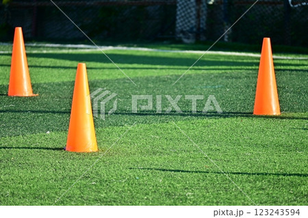 artificial green grass soccer field with orange training cones artificial green grass soccer field with orange training cones 123243594