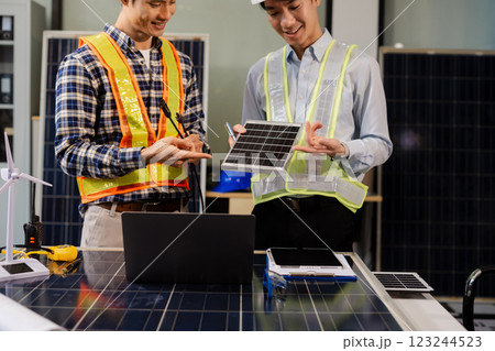Construction team, blueprint and site building job for architect, builder and engineer sketching a construction project, green energy and solar panel concept 123244523
