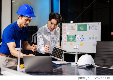 Construction team, blueprint and site building job for architect, builder and engineer sketching a construction project, green energy and solar panel concept Construction team, blueprint and site building job for architect, builder and engineer sketching a construction project, green energy and solar panel concept 123244546