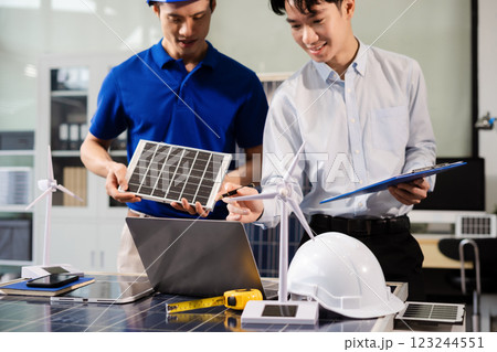 Construction team, blueprint and site building job for architect, builder and engineer sketching a construction project, green energy and solar panel concept Construction team, blueprint and site building job for architect, builder and engineer sketching a construction project, green energy and solar panel concept 123244551