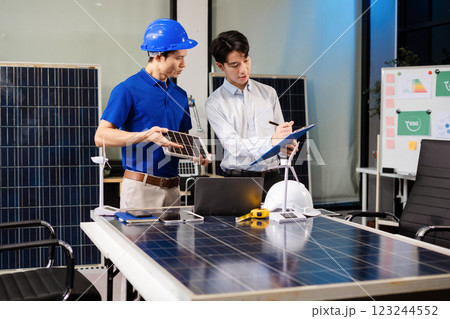 Construction team, blueprint and site building job for architect, builder and engineer sketching a construction project, green energy and solar panel concept 123244552