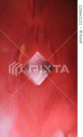 Glitter cube. Smooth paint wave. Red color ink cloud sparkling smoke glowing texture waves fume fog mist on abstract art background. Glitter cube. Smooth paint wave. Red color ink cloud sparkling smoke glowing texture waves fume fog mist on abstract art background. 123244621