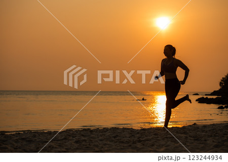 Silhouette athletic woman jogging exercise and relax and freedom on sand beach. 123244934