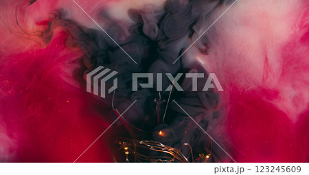 Ink swirling. Smoke explosion. Magic mixing pink black grey foggy liquid paint small particles background texture with broken glass light equipment. 123245609