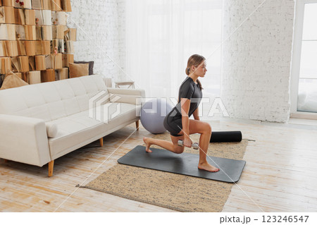 Slender girl in sportswear doing physical exercises. healthy lifestyle. 123246547