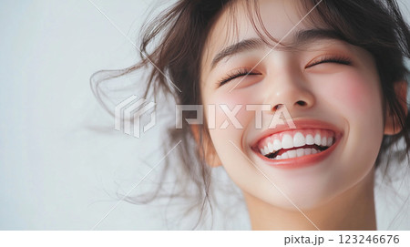 Radiant Joy: Close-up of a smiling woman with closed eyes, showcasing happiness, healthy teeth, and a clean, bright complexion. Radiant Joy: Close-up of a smiling woman with closed eyes, showcasing happiness, healthy teeth, and a clean, bright complexion. 123246676