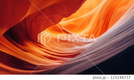Abstract rock formation showing layers of red, orange, and purple rock creating a swirling, textured pattern in a canyon. 123246737