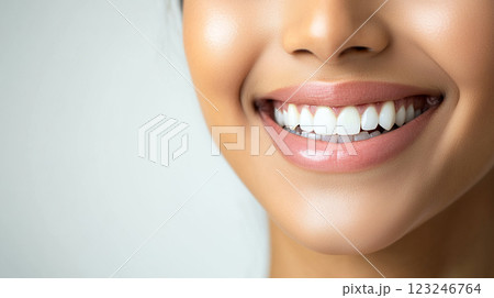 Close-up of a woman's radiant smile, showcasing healthy teeth and a confident expression. She appears to be in bright, natural lighting. Close-up of a woman's radiant smile, showcasing healthy teeth and a confident expression. She appears to be in bright, natural lighting. 123246764