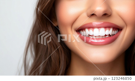Radiant smile showcasing healthy teeth. Perfect oral hygiene with bright, white teeth and glossy lips create a captivating and inviting look. 123246850