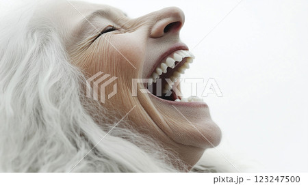 Close-up of a mature person with white hair expressing intense emotion through laughter or shouting with an open mouth. Close-up of a mature person with white hair expressing intense emotion through laughter or shouting with an open mouth. 123247500