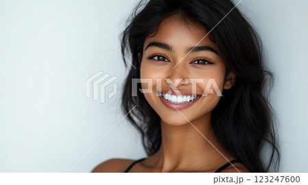 Radiant smile of a beautiful young woman with dark hair and glowing skin, confidence and joy evident in her expressive eyes. Radiant smile of a beautiful young woman with dark hair and glowing skin, confidence and joy evident in her expressive eyes. 123247600