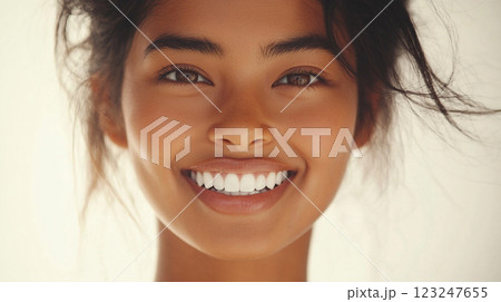 Radiant woman with a captivating smile, her eyes sparkling with joy. A portrait of natural beauty and confidence. Clean and healthy teeth. 123247655