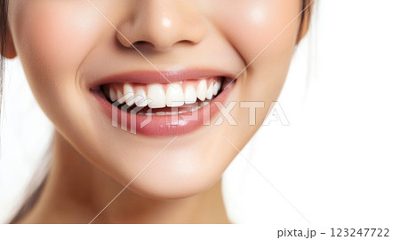 A close-up shot of a woman's radiant smile highlighting clean and straight teeth. Skin is soft with pinkish lips. Dental health concept. 123247722