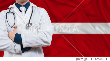 Male Doctor With Stethoscope On Latvia Flag. Doctor Holding Stethoscope On Latvia Flag Male Doctor With Stethoscope On Latvia Flag. Doctor Holding Stethoscope On Latvia Flag 123250001