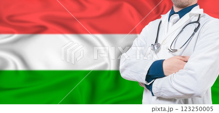Hungary Health Care Concept. Male Doctor on Hungary Flag. Doctor With Crossed Arms on Hungary Flag 123250005