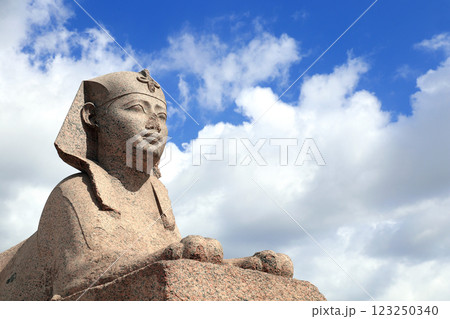 Famous Sphinx in Serapeum of Alexandria, Egypt, North Africa. Roman temple Serapeum with Pompey's pillar and sphinx. On blue sky and white clouds background 123250340