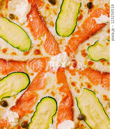 Salmon and zucchini dish beautifully arranged on a plate 123250519