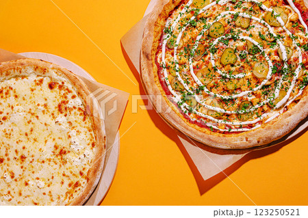 Delicious pizzas with unique toppings on vibrant background 123250521