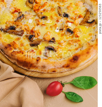 Freshly baked chicken and mushroom pizza on wooden board 123250563