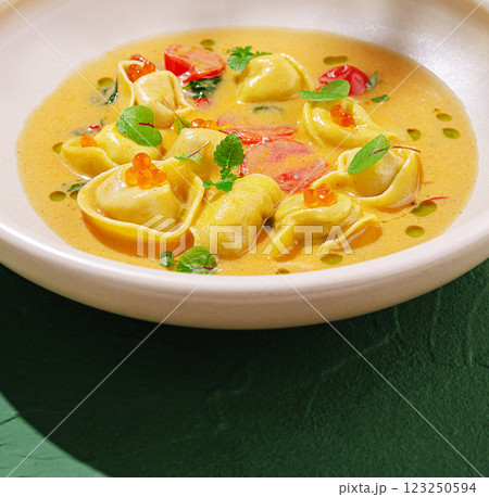 Flavorful tortellini served in a creamy herb sauce Flavorful tortellini served in a creamy herb sauce 123250594