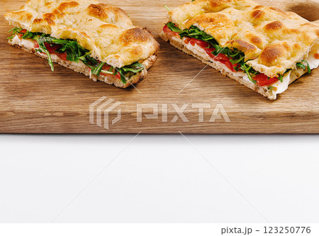Freshly baked italian panini on wooden board Freshly baked italian panini on wooden board 123250776
