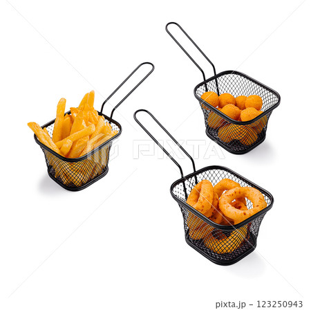 Three serving baskets with various fried snacks on a table 123250943