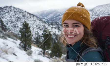 Travel, hiking, adventure, traveler hiker woman stands in the mountains looking at camera 123251459