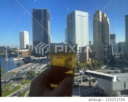 glass of beer in hand against the backdrop of a cityscape in Japan glass of beer in hand against the backdrop of a cityscape in Japan 123251726