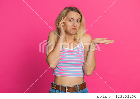 Confused woman feeling embarrassed about question, having doubts, no answer, clueless, uncertain 123252250
