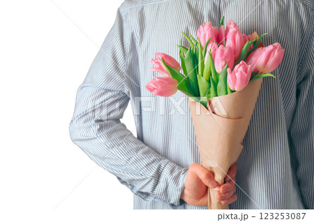 8 March, International Women's Day, a bouquet of pink tulips wrapped in paper behind a man's back, isolated on white background, PNG 8 March, International Women's Day, a bouquet of pink tulips wrapped in paper behind a man's back, isolated on white background, PNG 123253087