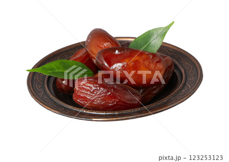Dried dates in a bronze authentic saucer, close up, isolated on white background, PNG Dried dates in a bronze authentic saucer, close up, isolated on white background, PNG 123253123