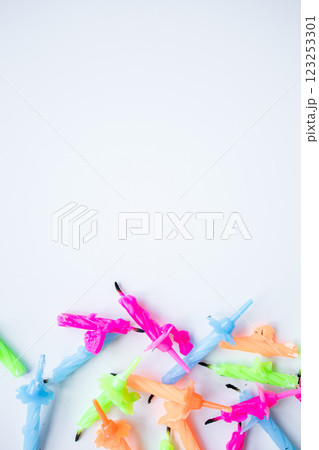 Colorful birthday candles arranged on white background 123253301