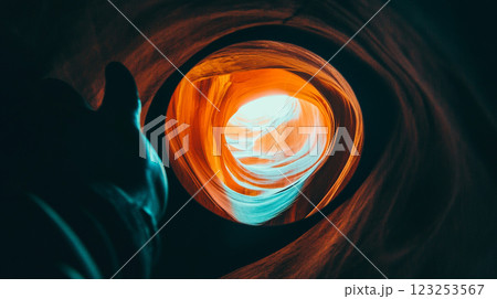 Dramatic rock formation with swirling orange and teal hues, contrasting light and shadow, creating an abstract geological spectacle. 123253567