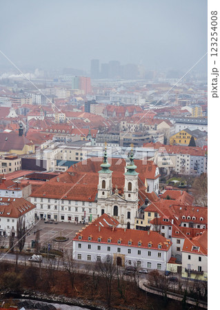Graz cityscape on foggy day. Panoramic view of Graz, Austria with historical architecture. Streets with red roofed buildings in European city Graz cityscape on foggy day. Panoramic view of Graz, Austria with historical architecture. Streets with red roofed buildings in European city 123254008