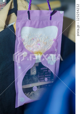 Purple hanging moisture absorber bag collecting humidity in a closet space. High quality photo Purple hanging moisture absorber bag collecting humidity in a closet space. High quality photo 123254212