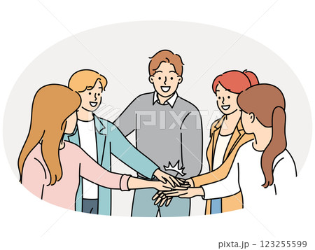 Happy colleagues stack hands involved in teambuilding Happy colleagues stack hands involved in teambuilding 123255599