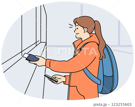 Smiling girl buy tickets at railway station Smiling girl buy tickets at railway station 123255603