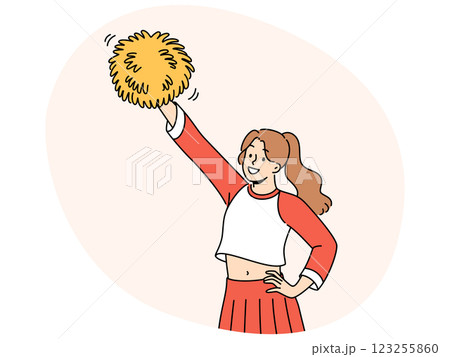 Young woman cheerleader raises hand with pumpon up supporting college soccer team Young woman cheerleader raises hand with pumpon up supporting college soccer team 123255860