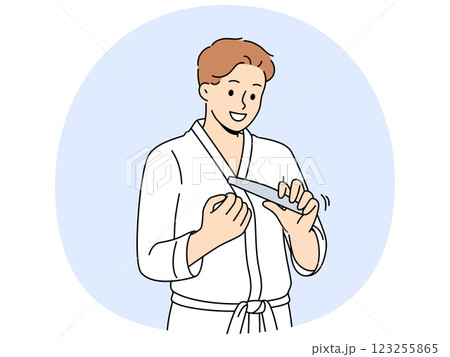 Man uses nail file after shower, performing daily hygiene and SPA procedures to take care of skin Man uses nail file after shower, performing daily hygiene and SPA procedures to take care of skin 123255865