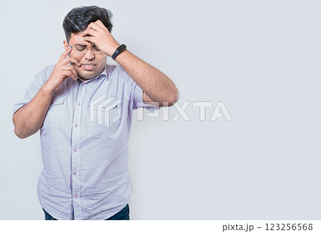 Exhausted person putting the palm of his hand on his face. Fatigued and exhausted man isolated. Concept of a bored and tired man Exhausted person putting the palm of his hand on his face. Fatigued and exhausted man isolated. Concept of a bored and tired man 123256568