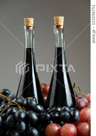 Balsamic vinegar in bottles among grapes Balsamic vinegar in bottles among grapes 123256751