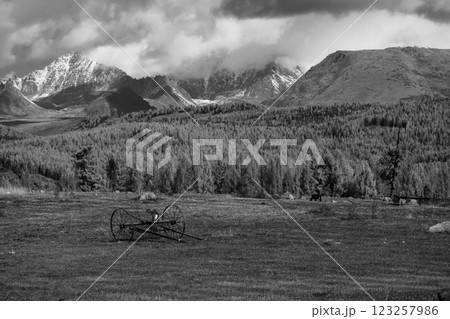 Peaceful landscape of mountains and field under cloudy sky in black and white Peaceful landscape of mountains and field under cloudy sky in black and white 123257986