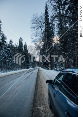 Car on the road in a snowy forest 123259721